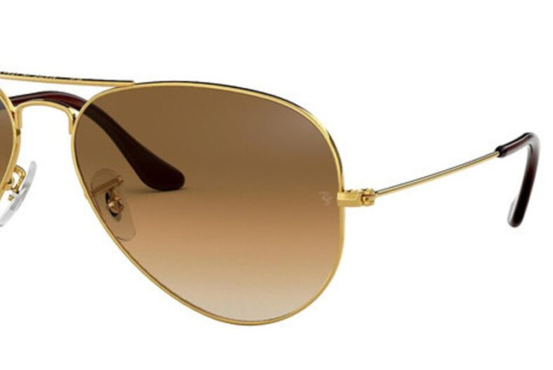 Gold Ray-Ban aviator sunglasses, brown gradient lenses.